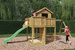 Plac zabaw drewniany ogrodowy Pluto KDI domek, zjeżdżalnia, 2x huśtawka, 2x piaskownica, stół piknikowy, ścianka wspinaczkowa
