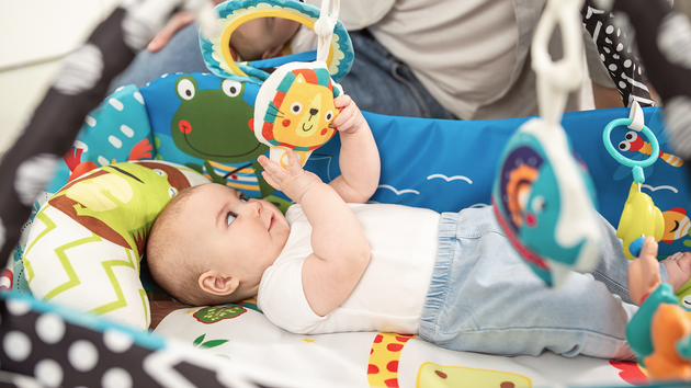 Lionelo Duża Mata edukacyjna Anika Multicolor 2w1 + zabawki i poduszka
